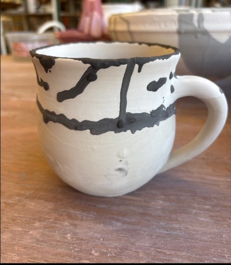 Untitled — a white mug with black drips run down it, still an idea