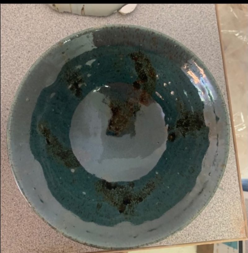 starry night + aqua bowl, from above — a teal ring around a pale center, dark flecks burnt in