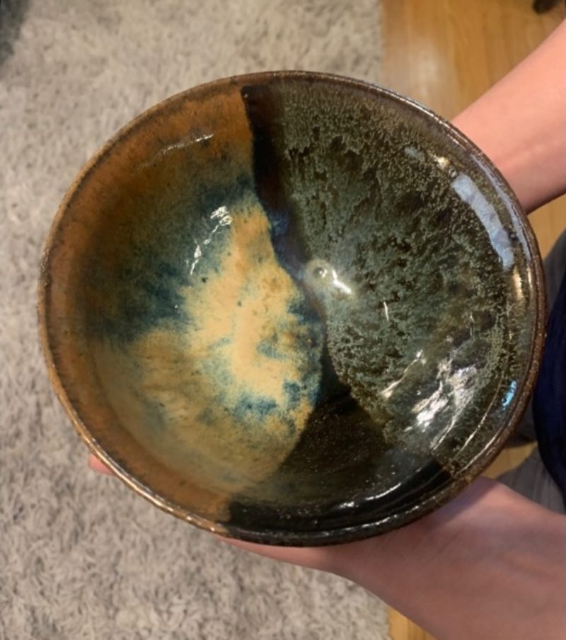 starry night with aqua and coastal, three — the bowl held in one hand, half gold, half dark green