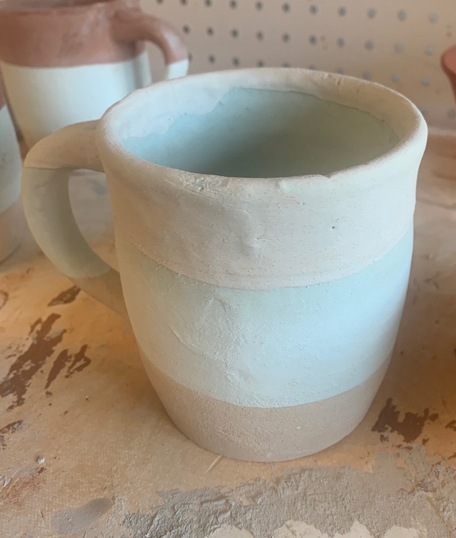 aqua and cream mug, unfired — bands of aqua and cream on the bench