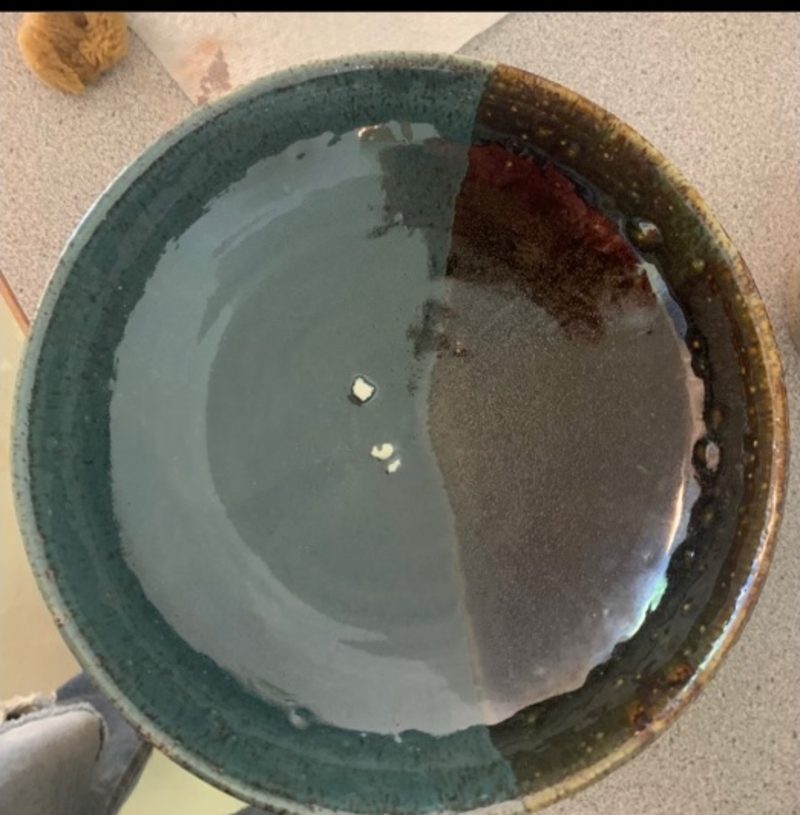 aqua + starry night bowl, from above — pale aqua on one side, dark brown-green on the other
